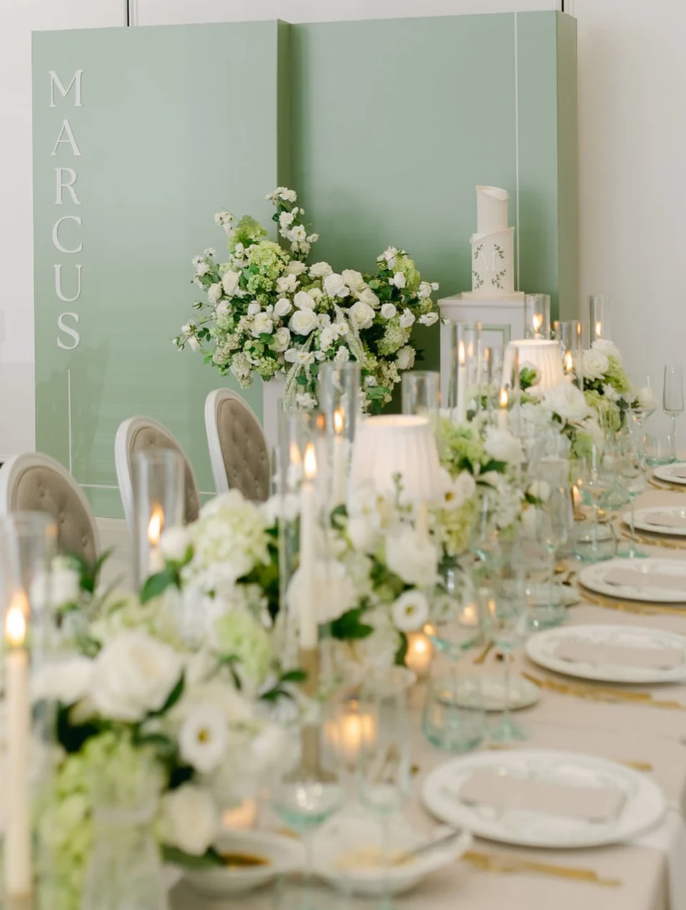 A real family celebration table with white flowers and sage green details