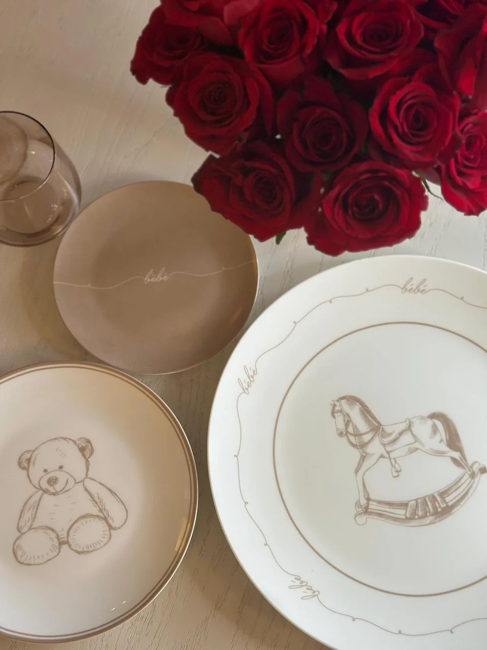Bébé Collection plates styled with rich red roses