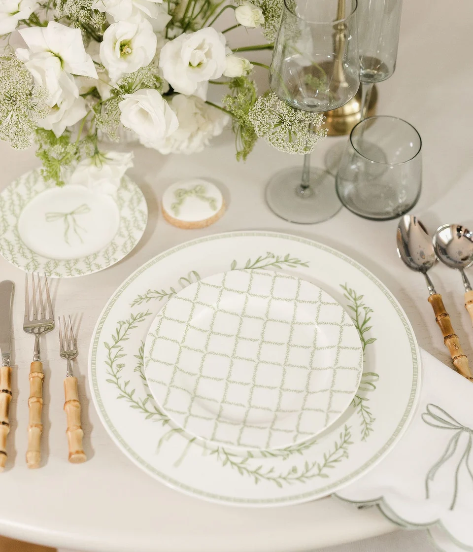 Sage patterned tableware, bamboo flatware and flowers set for a celebration